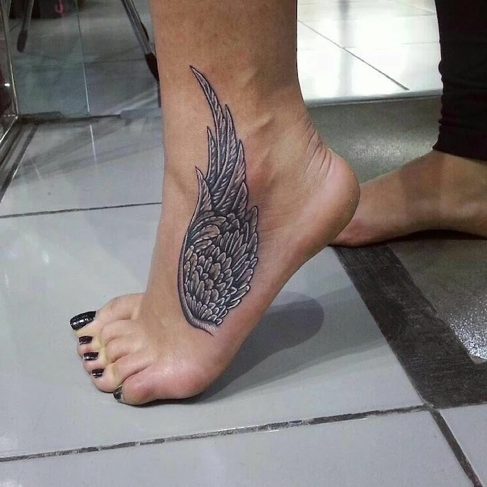 leg tattoo, angel wing, black nail polish, white tiled floor, angel and devil tattoo