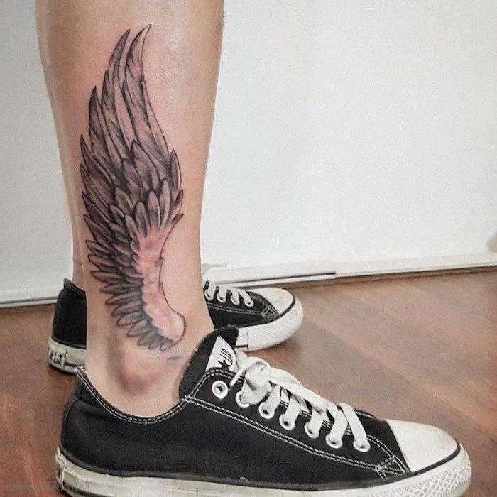 angel sleeve tattoo, leg tattoo, black converse sneakers, wooden floor, white wall