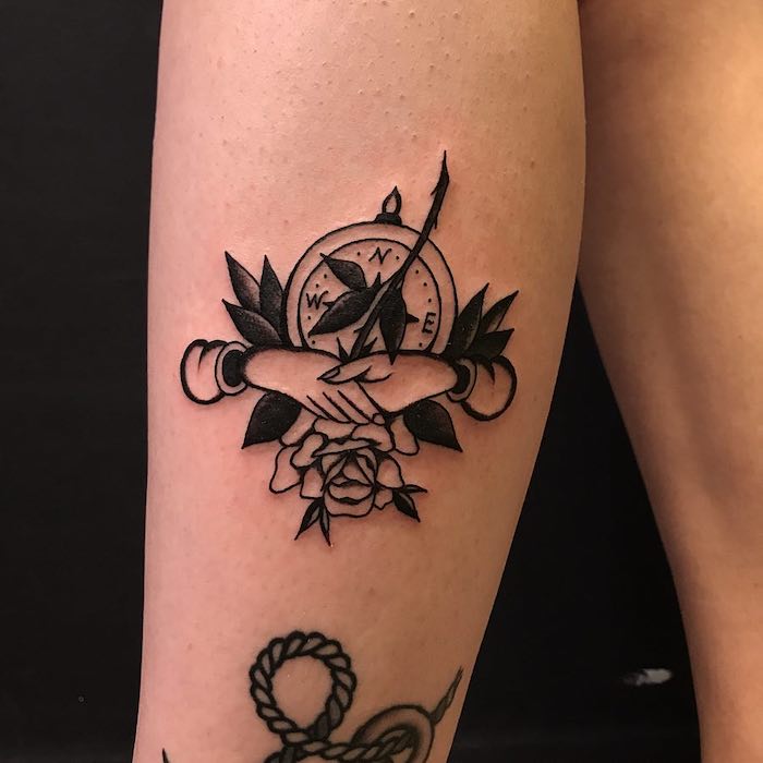 shaking hands, rose covering a compass, compass arrow tattoo, leg tattoo, black background
