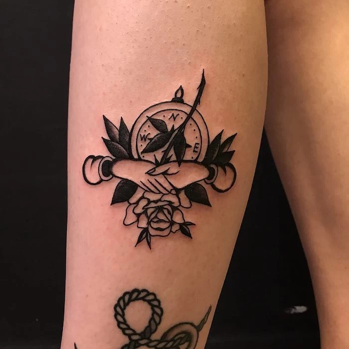 shaking hands, rose covering a compass, compass arrow tattoo, leg tattoo, black background