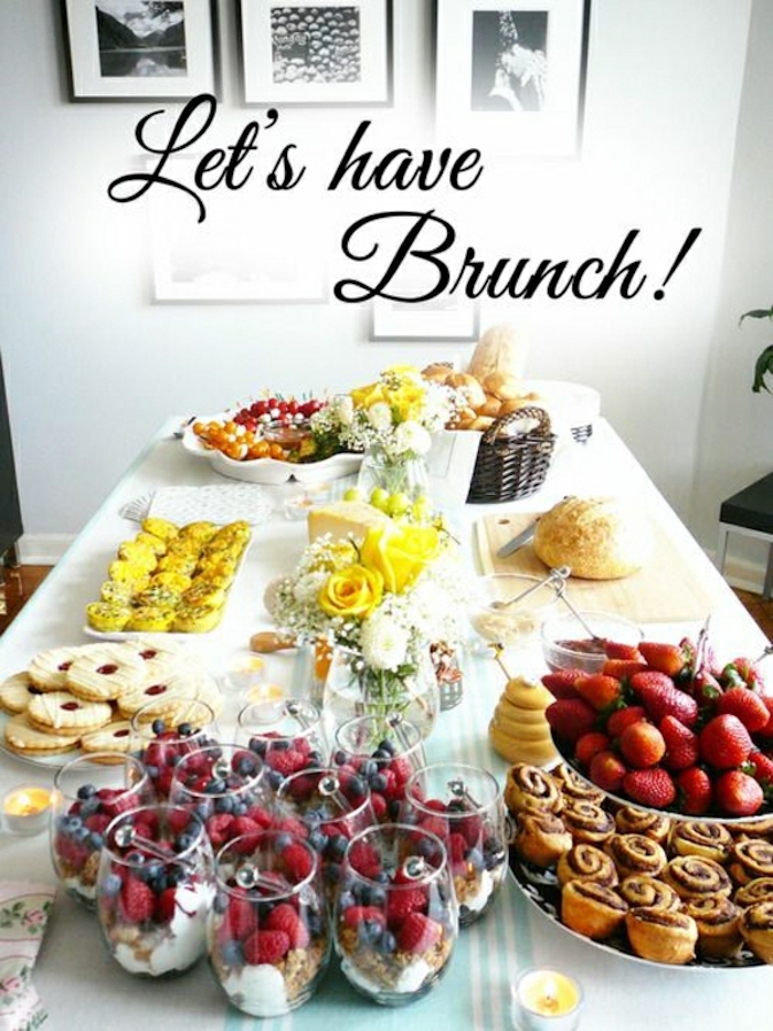 let's have brunch, brunch items, brunch table, granola and yoghurt, different fruits, cinnamon buns