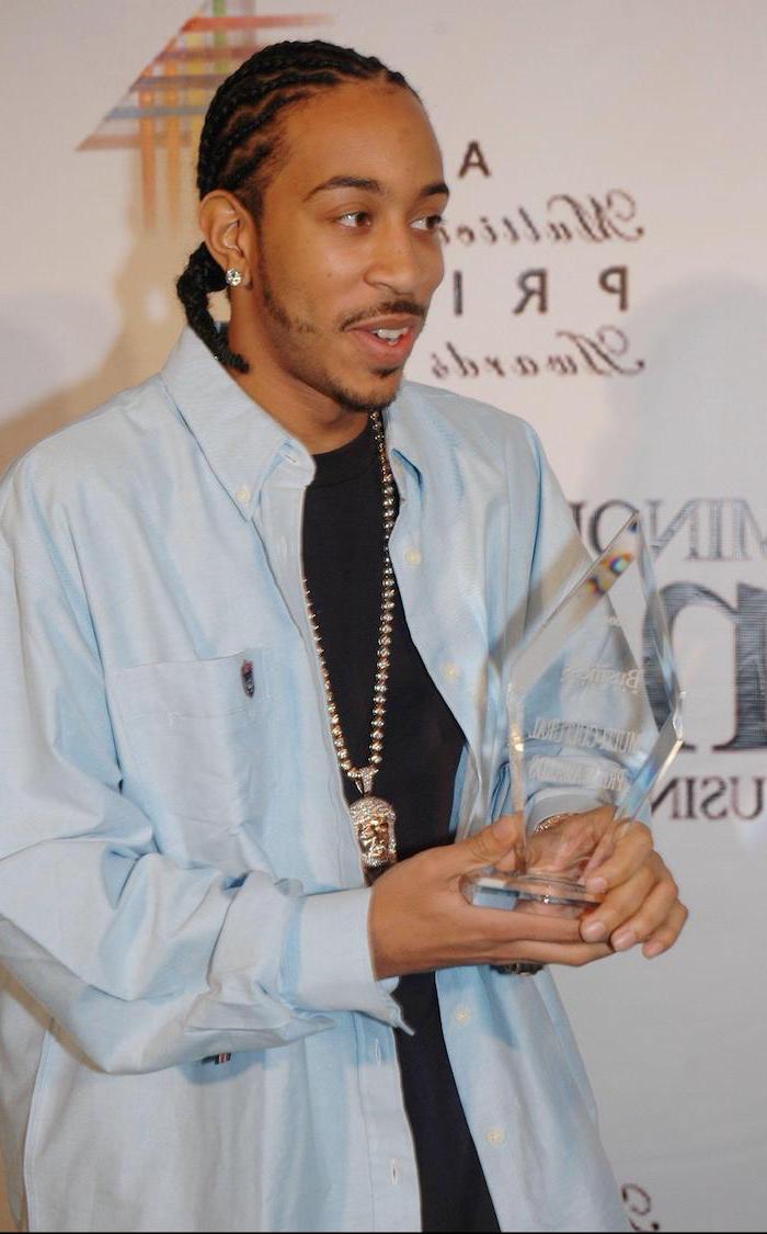 braids hairstyles 2019, ludacris holding an award, wearing a blue shirt, black t shirt, silver necklace