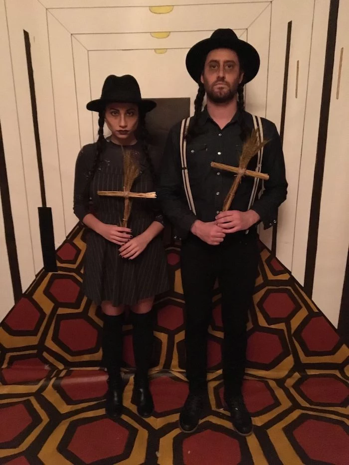 man and woman, dressed in all black, holding wooden crosses, creative halloween costumes, braided hair