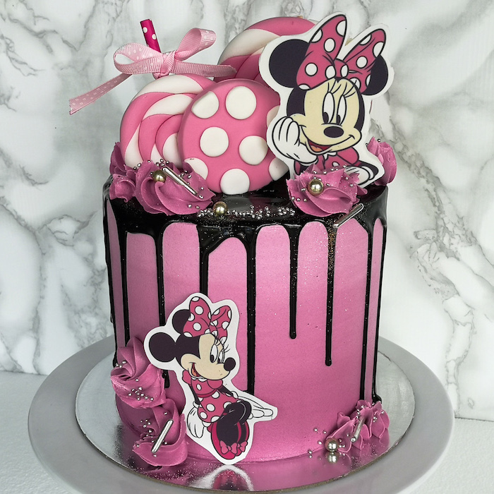 pink fondant, black frosting, minnie mouse cupcakes, candy decorations, marble background