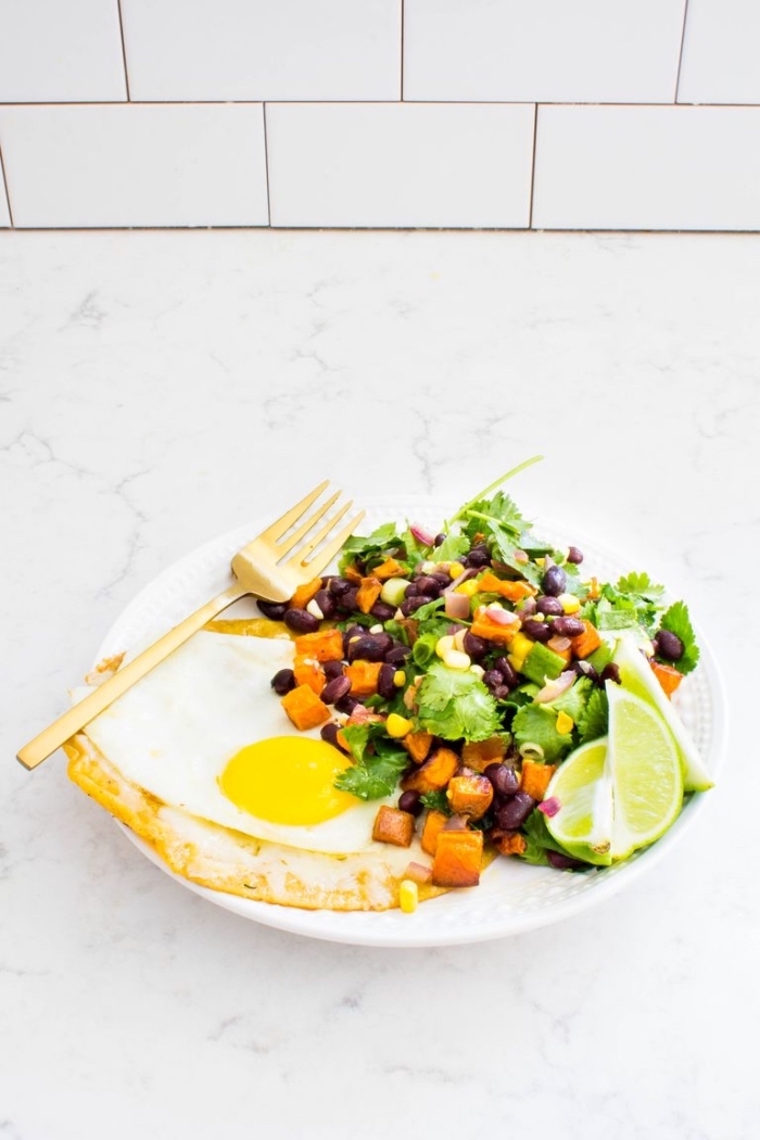 marble countertop, brunch items, egg toast, with green salad, lime slices, white plate