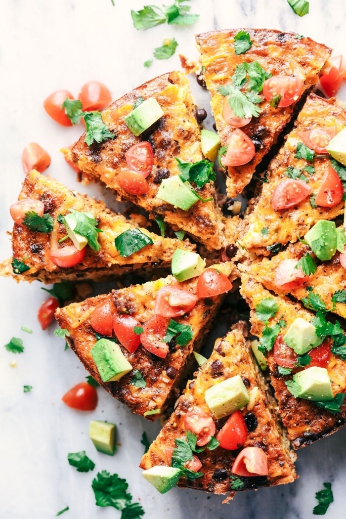 brunch potluck ideas, baked casserole, chopped avocado and tomatoes, marble countertop