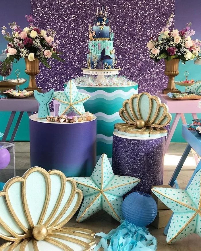 purple gold and turquoise decor, mermaid baby shower, large flower bouquets, three tier cake