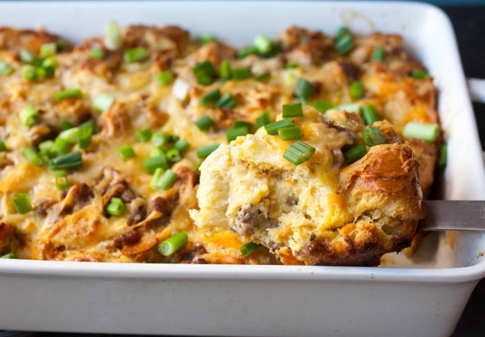 baked casserole, with meat and eggs, chives on top, brunch potluck ideas, silver spatula