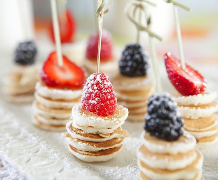 stacks of mini pancakes, raspberry and strawberry, blackberry on top, easy brunch ideas, powdered sugar