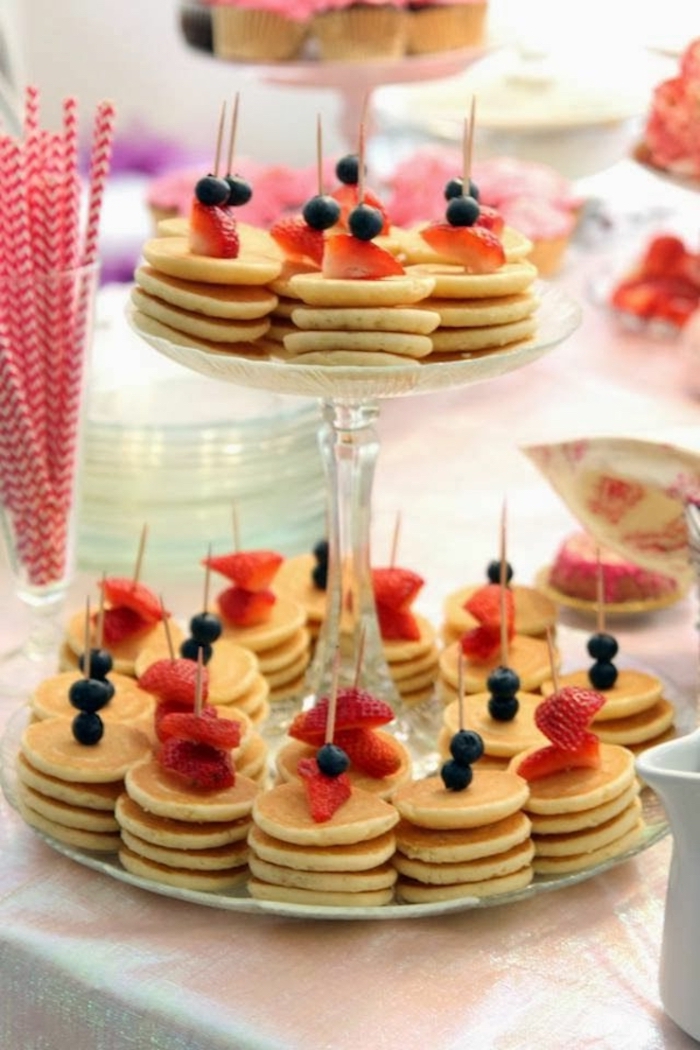 mini pancakes, easy brunch ideas, blueberries and strawberries on top, glass cake stand, paper straws