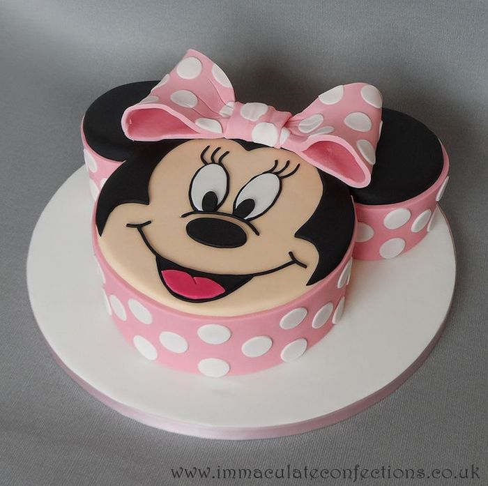 minnie mouse cake ideas, cake in the shape of minnie's head, pink fondant, pink bow, white tray