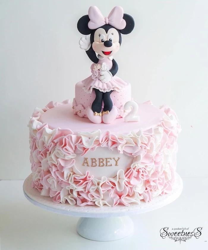 minnie mouse cake topper, pink fondant, pink and white frosting, white cake stand