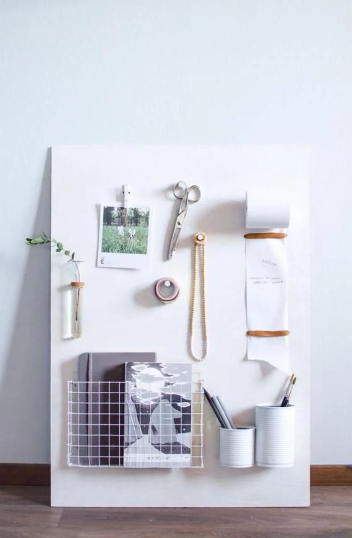 wooden board, photos and scissors pinned to it, wooden desk, white wall, office decor ideas for work