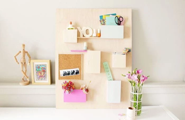 wooden board, with small shelves, office decor ideas for work, white desk, pink flower bouquet, framed art