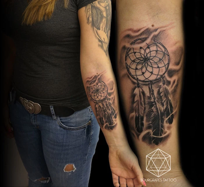 forearm tattoo, dream catcher tattoo on arm, woman with black t shirt, ripped jeans, blonde hair
