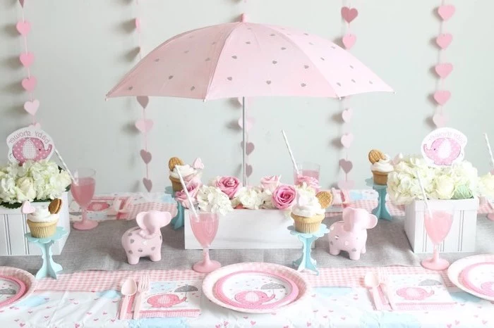 pink umbrella, pink hearts garland, flower bouquets, in wooden crates, table setting, baby shower table decorations