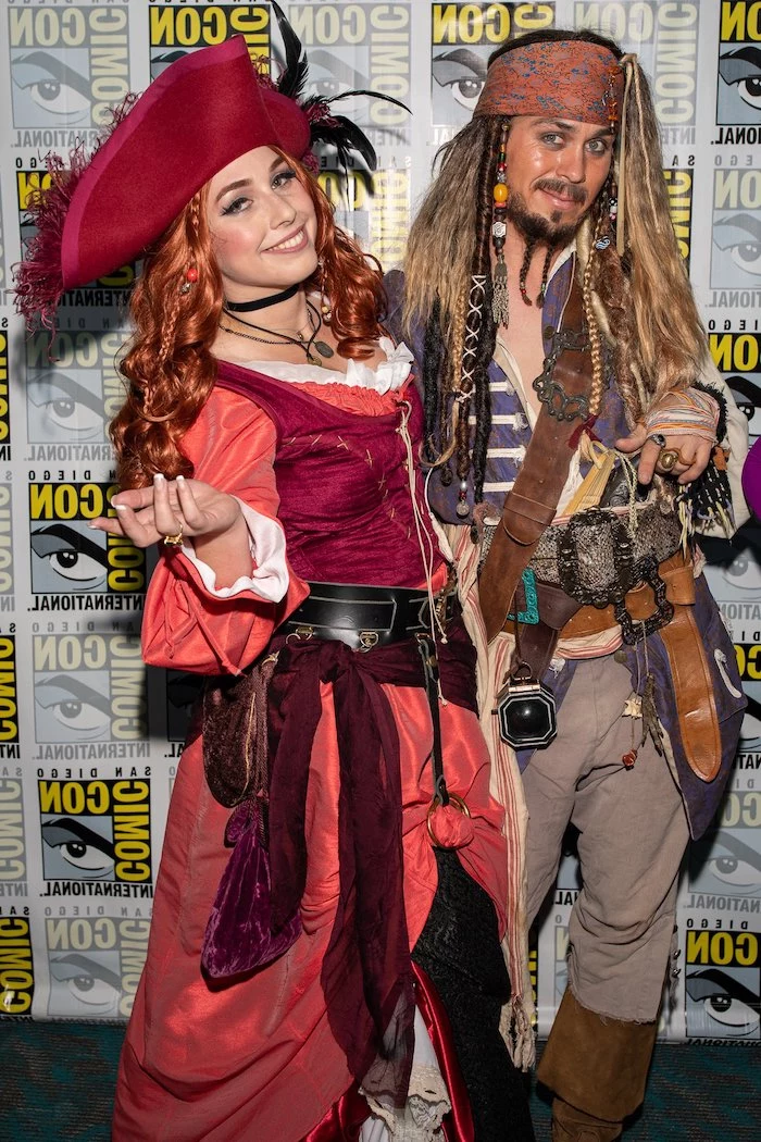 man and woman smiling, halloween costumes ideas for adults, jack sparrow, pirates costumes, pirates of the caribbean