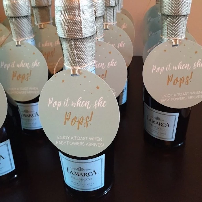 pop it when she pops, small prosecco bottles, unique gender reveal party ideas, wooden table