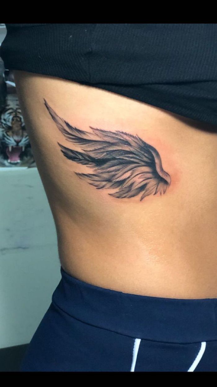 angel wing tattoo, on the side of the body, angel sleeve tattoo, woman with black top, black pants