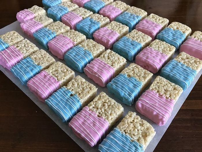 rice bars, pink and blue frosting, unique gender reveal party ideas, wooden table, grey tray