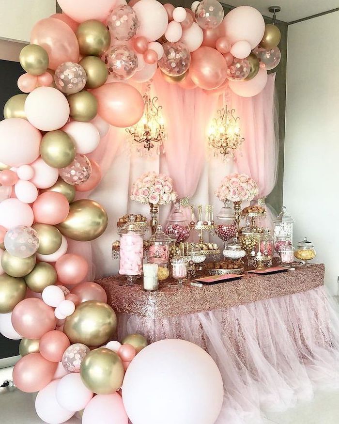 pink and gold baby shower, large balloon arch, pink tulle, gold sequins, flower bouquets, dessert table
