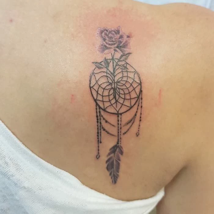 shoulder tattoo, dream catcher tattoo on arm, purple feather, purple rose, white blouse