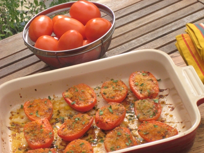 brunch recipe ideas, baked halved tomatoes, white casserole, wooden table, tomatoes in a bowl