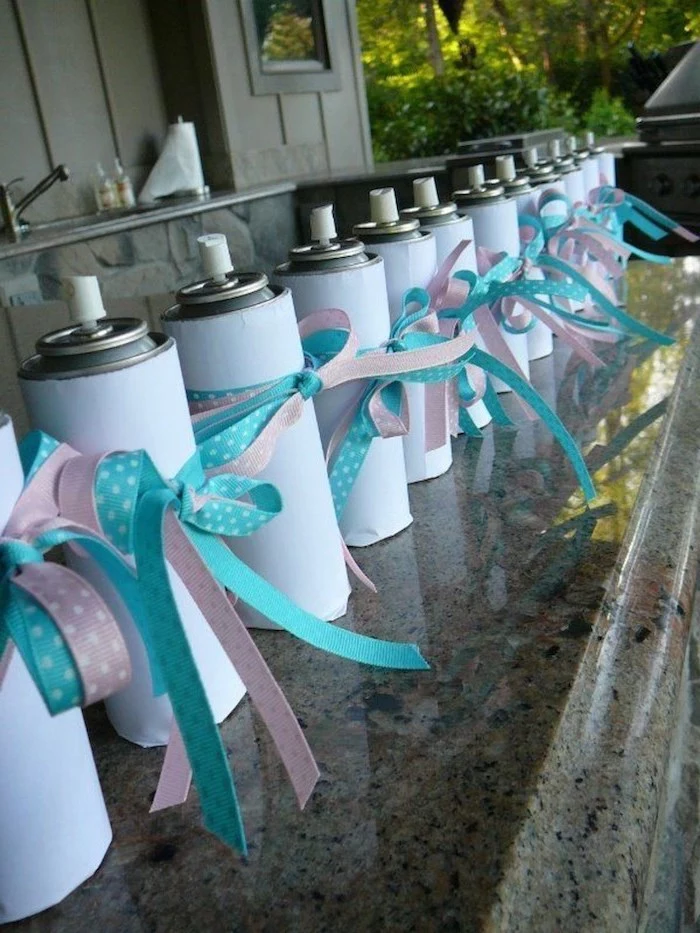white spray cans, unique gender reveal party ideas, pink and blue ribbons