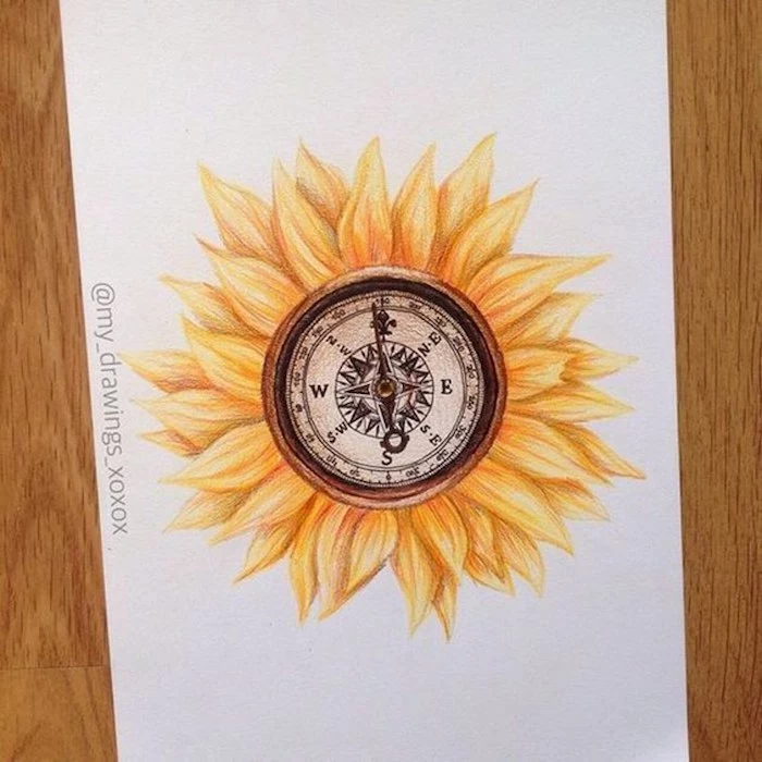 sunflower drawing, compass in the middle, simple compass tattoo, wooden table, white paper