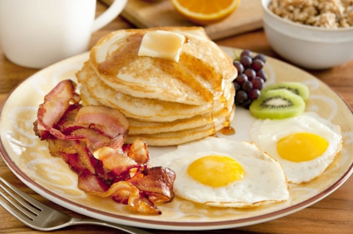 stack of pancakes, with butter and honey, fried eggs, bacon on the side, things to make for breakfast