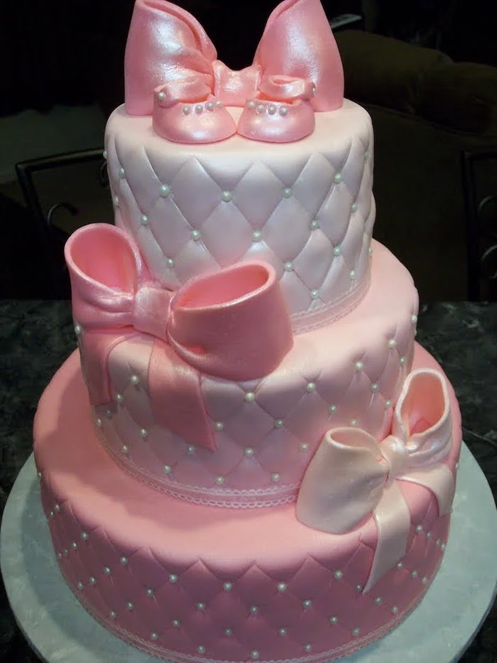 three tier cake, with pink and white fondant, pink bows, silver cake tray, minnie mouse baby shower