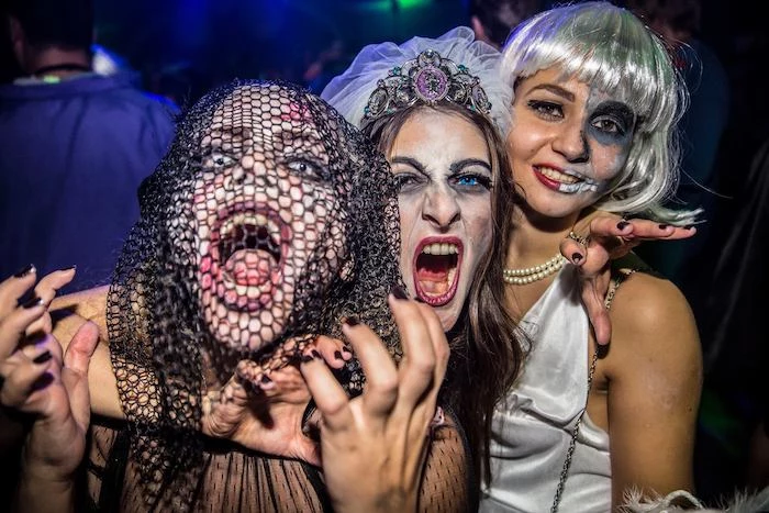 three women, posing for a picture, wearing scary make up, contact lenses, funny halloween costumes