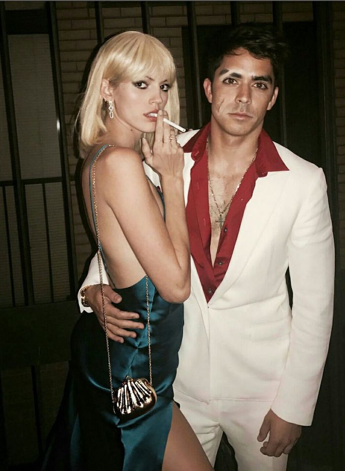 tony montana and elvira, woman with blue silk dress, last minute halloween costumes, man with white suit