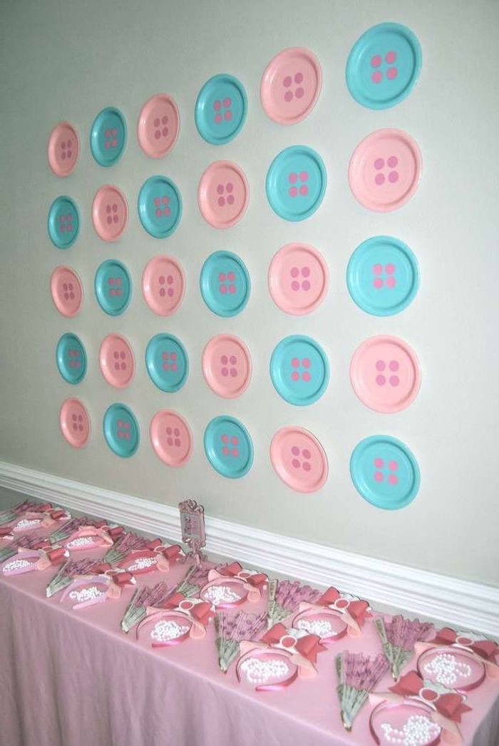 blue and pink, button shaped plates, on the wall, gender reveal cake ideas, pink tablecloth