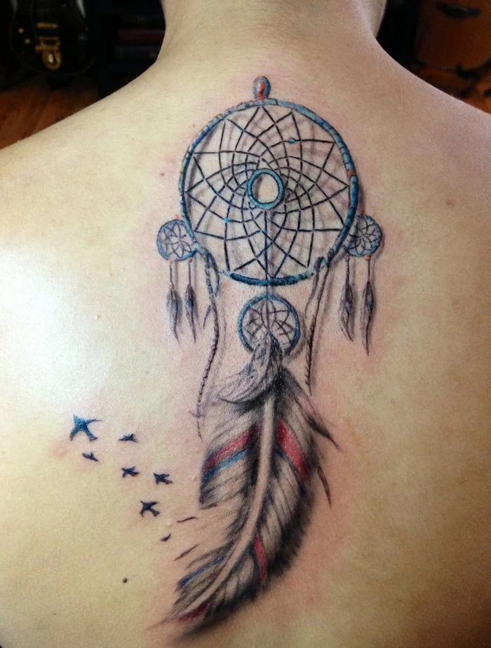 back tattoo, small dream catcher, birds flying, wooden floor, in the background