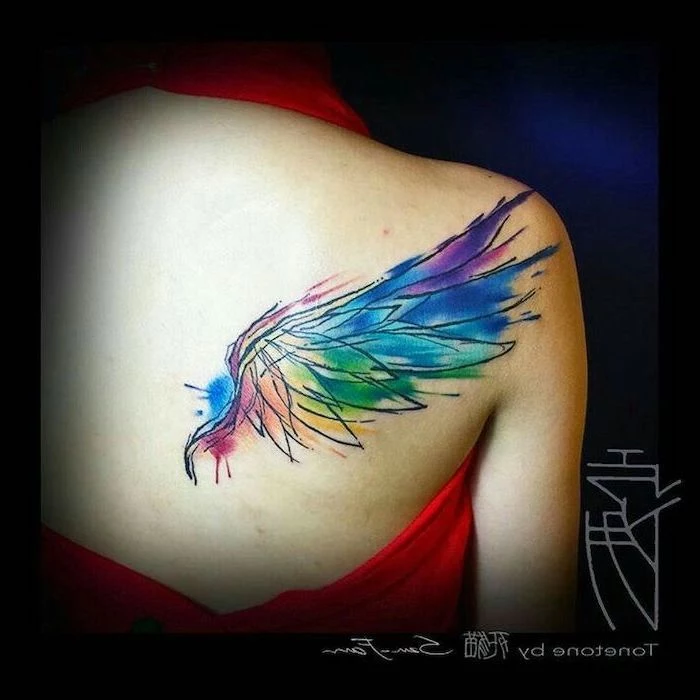 watercolor tattoo, cross with wings tattoo, back of shoulder tattoo, red top, black background
