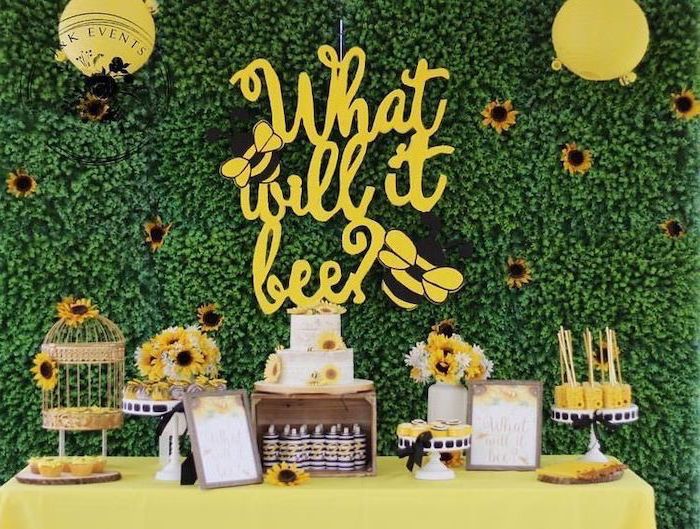 what will it bee, dessert table, gender reveal smoke cannon, greenery wall, sunflowers and balloons