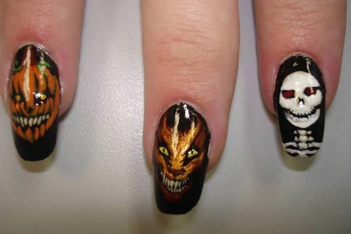 black nail polish, skeleton and monsters, orange decorations, squoval nails, orange ombre nails