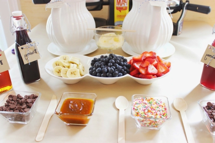 bowls of bananas, blueberries and strawberries, chocolate chips, caramel sauce and sprinkles, what to serve for brunch