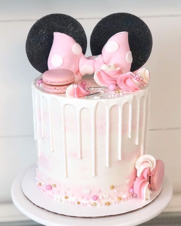white fondant, white frosting, pink macaroons, minnie mouse 1st birthday cake, black ears