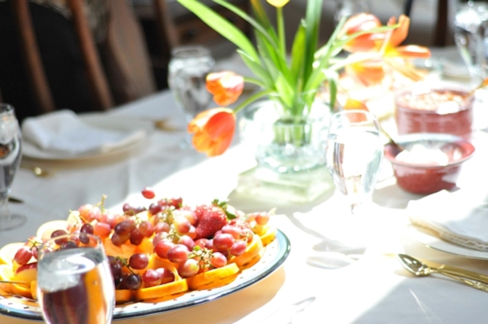 tulips bouquet, what to serve for brunch, fruit platter, orange and grapes, water glasses