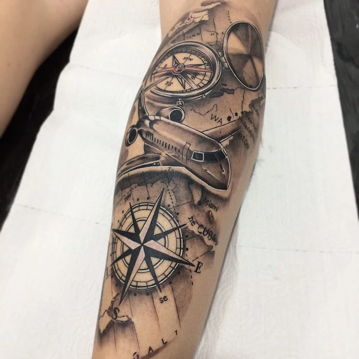 flying airplane, map of the world, compass meaning, forearm tattoo, white sheet of paper