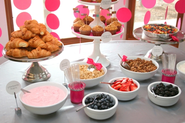 bowls of different fruits, breakfast finger foods, croissants, mini muffins, cake stands, brunch table