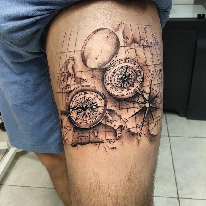 compass tattoo design, thigh tattoo, vintage map of the world, blue shorts, white tiled floor