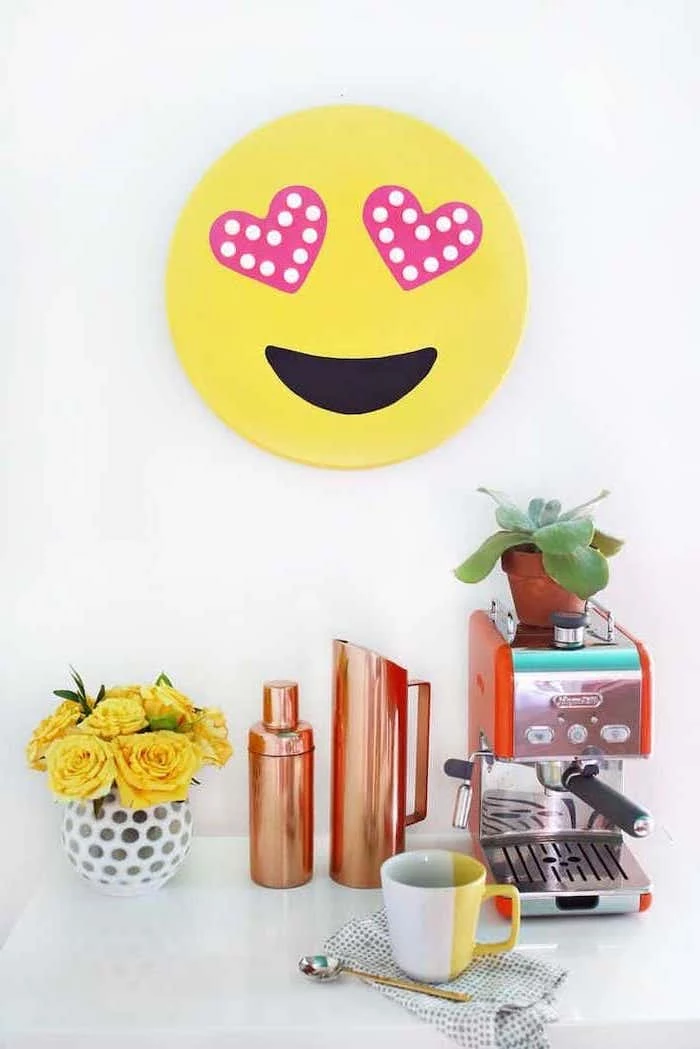 yellow emoji, hanging on white wall, coffee machine, yellow roses, flower bouquet, ideas for decorating your office at work