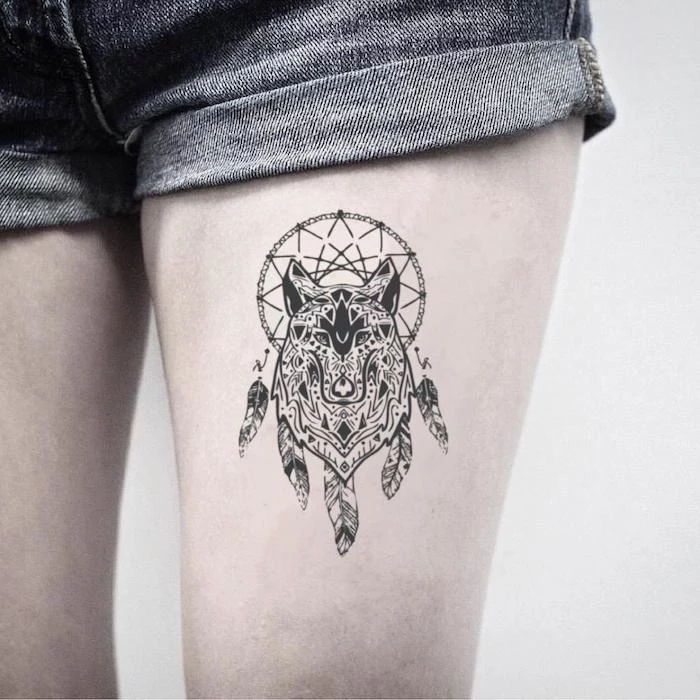 thigh tattoo, wolf tattoo, dream catcher tattoo ideas, white background, short jeans, dream catcher watercolor tattoo