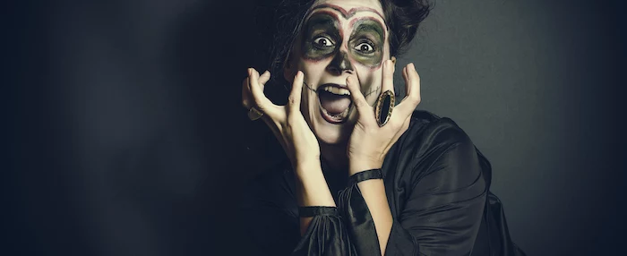 woman screaming, wearing scary make up, last minute halloween costumes, black silk dress, black background