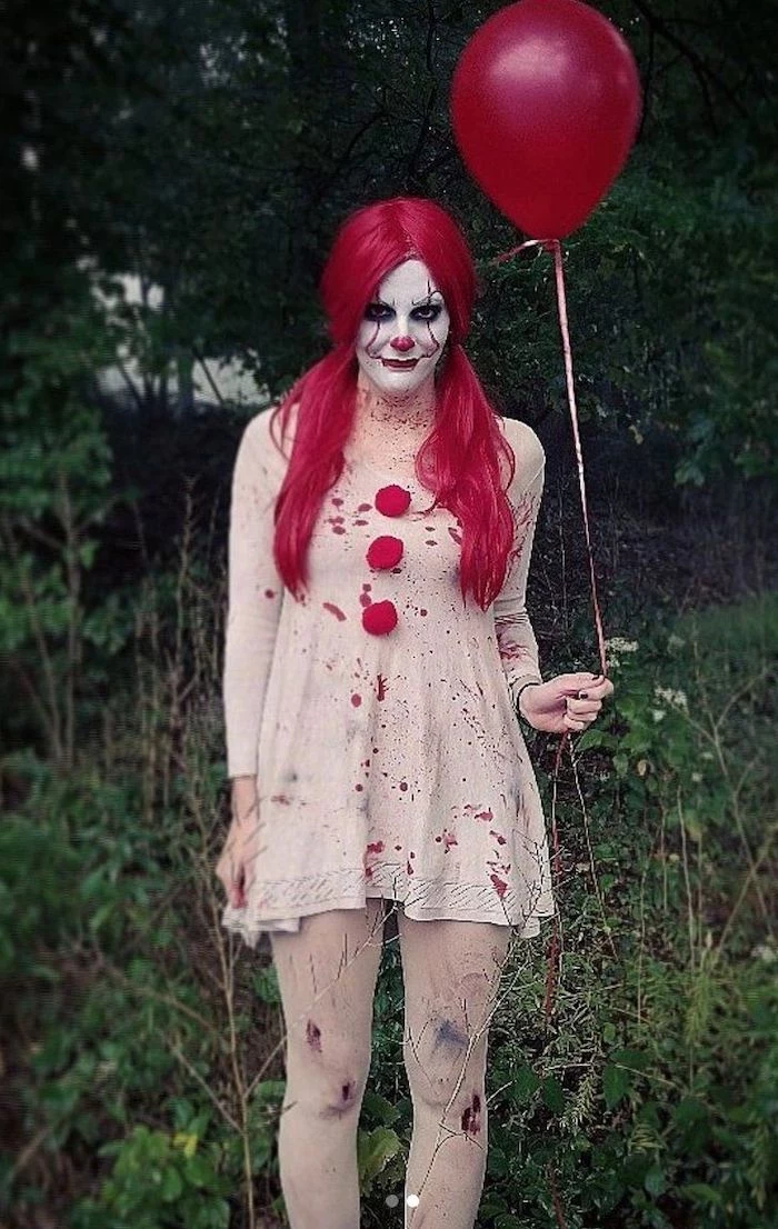 woman dressed as pennywise, holding a red balloon, easy halloween costumes for guys, red wig, clown make up