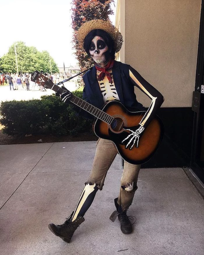 woman holding a guitar, easy halloween costumes for guys, skeleton costume, skeleton face make up