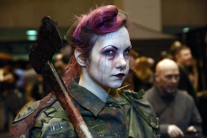 woman holding an axe, wearing a navy jacket, pink hair, face make up, easy halloween costumes for guys